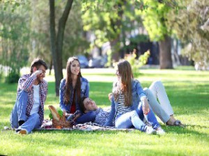 Happy friends on picnic in park